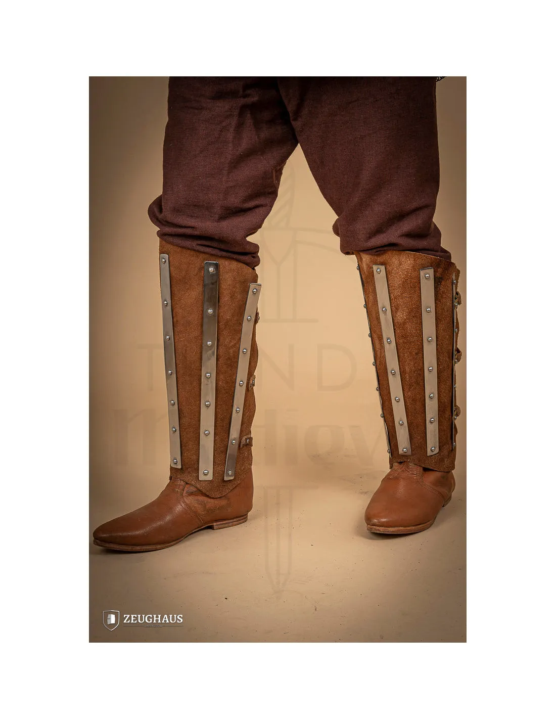 Medieval steel and brown suede leather greaves